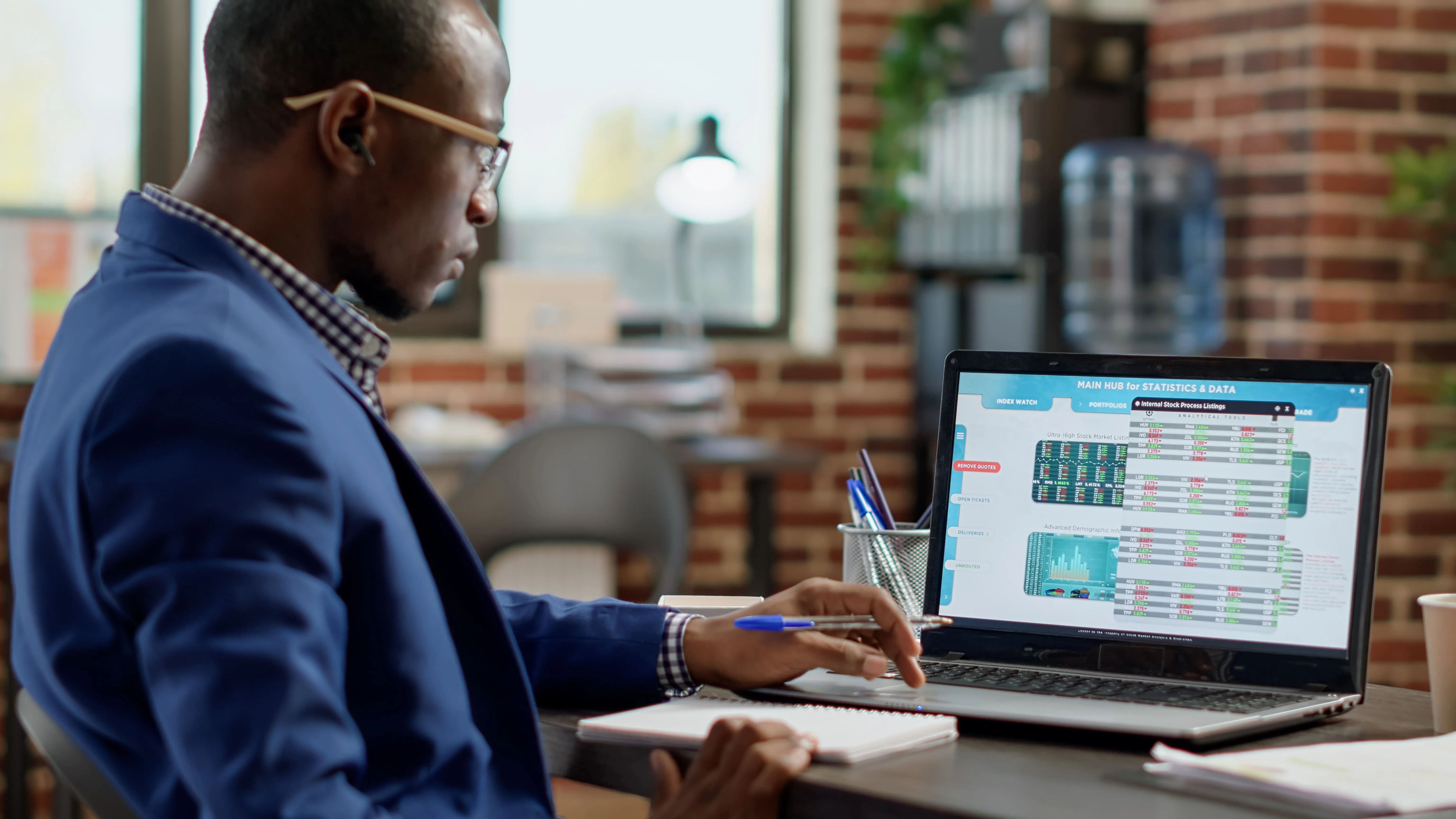 A close-up of a man using SaaS sales tax automation tools on a laptop